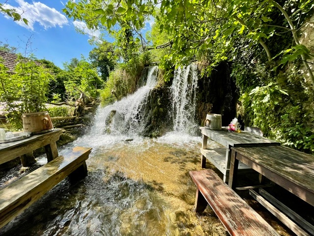 Krka National Park - Roski Slap - old mill with picnic tables in the water to cool off on a hot day