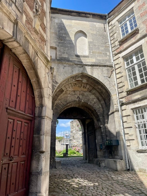 Gate to the park with palace stone ruins and Tourist Office, in Senlis, France